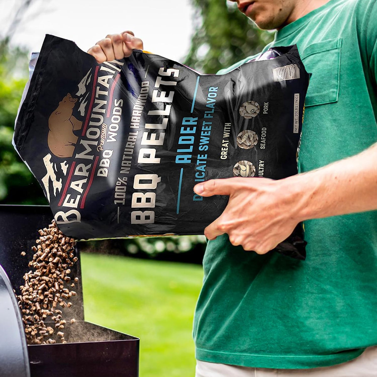 Bear Mountain — Alder pellets being poured into a grill hopper
