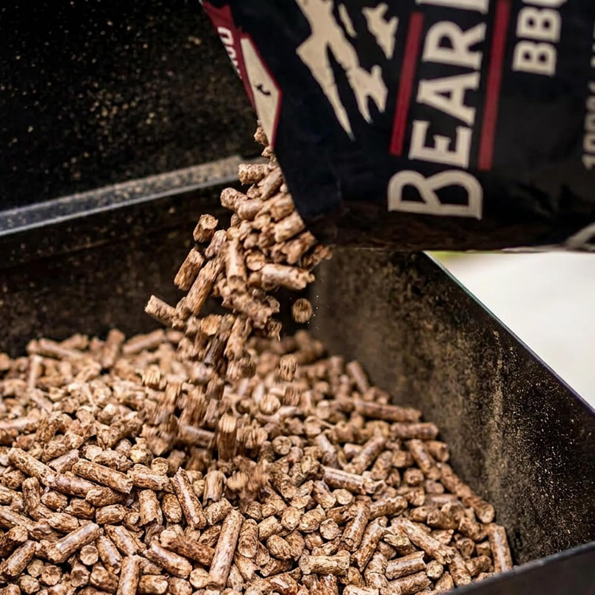 Bear Mountain — Gourmet Blend pellets being poured into a grill hopper