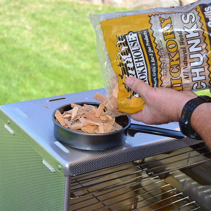 Smokehouse — Alder wood chunks being poured into a smoker pan